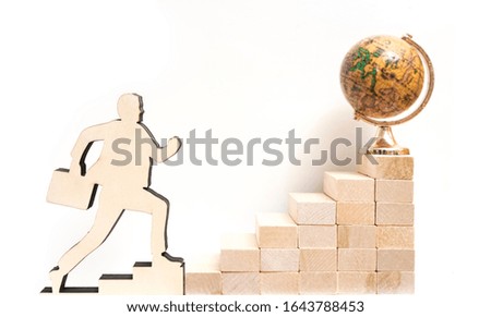 globe map on top of old wooden stairs with businessman climbing, isolated on white background.