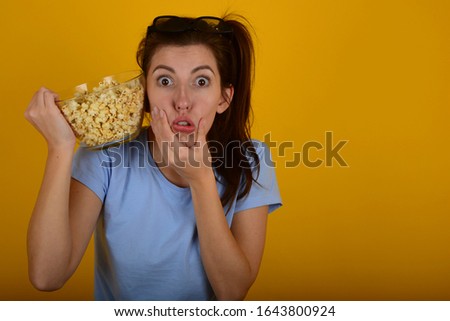 Crazy woman holds hands on her face with popocrome on a yellow background portrait