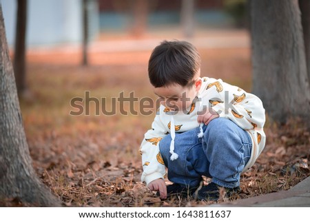 Children squatting on the grass playing