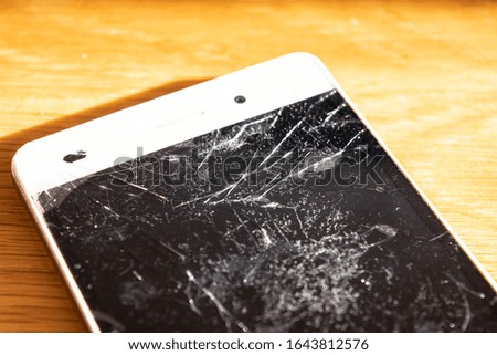 Broken white smartphone screen closeup