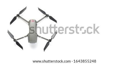 Modern drone quadcopter with a camera isolated on white background. Top view. Free space for your text.