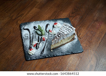 Close up on tasty slice of Delicate Airy Cheesecake on wooden background. delicious dessert cake after dinner. Food photo background for recipe or menu