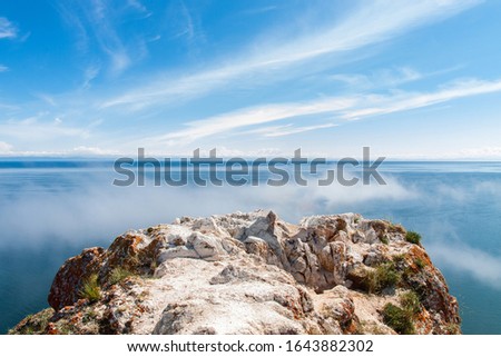 Bright blue sky over cliff on island of Olkhon above Lake Baikal