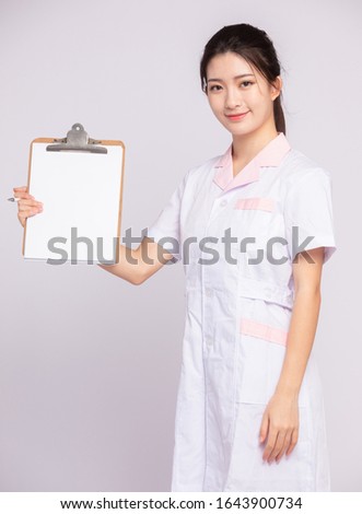 An Asian girl in white nurse's uniform
