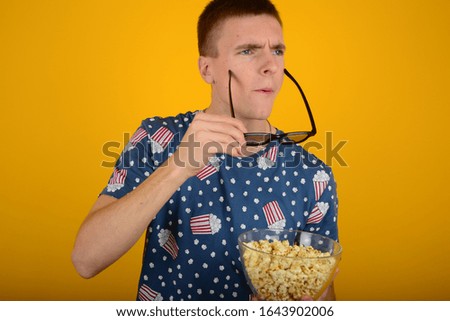 man with popcorn in 3D glasses cinema