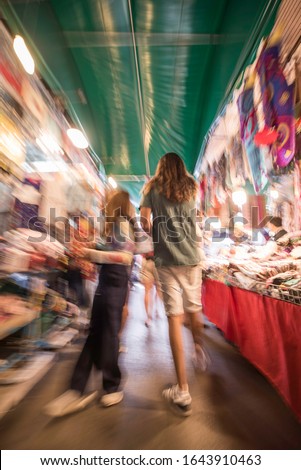 Blurry or blur. Long exposure in Chatuchak Weekend Market, popular tourists come to shop, taste street food during the weekend.
