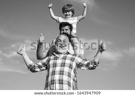 Father son and grandfather playing - family time together. Boy with father and grandfather. Male multi generation portrait. Three men generation