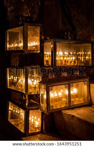 Glass-boxed menorahs at the entrance to the house at night