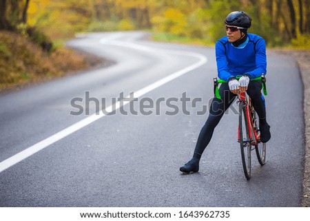 young man in bikers clothes riding a racing bicycle
