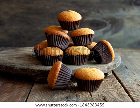 Muffins - delicious pastries. Delicious dessert on the table - homemade muffins. Portioned cupcakes. Simple muffin. Royalty-Free Stock Photo #1643963455