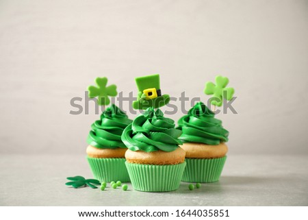 Delicious decorated cupcakes on light table. St. Patrick's Day celebration