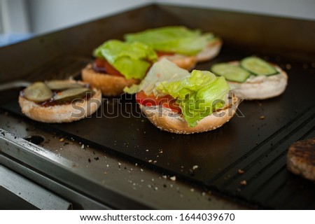 Grilling an vegetarian burgers on an outdoor grill.