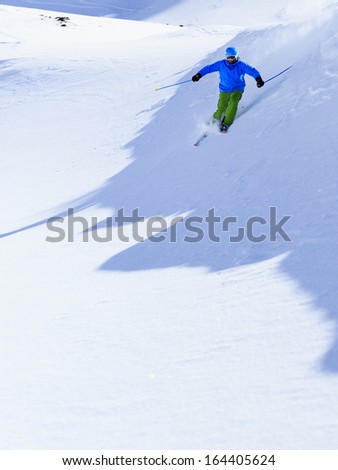 Skiing, Skier, Freeride in fresh powder snow - man skiing downhill