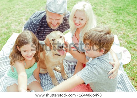 Happy family making a selfie, for the dog is not very important. Parents and children having fun in the holiday. Travel , holidays and love concept. Focus on the dog - Image