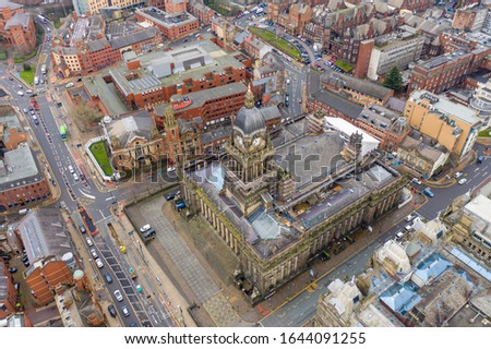 Leeds Town Hall aerial photo over looking the whole of the Leeds City Centre in West Yorkshire in the UK and showing the Leeds Town Hall historical building and roads along side the building.