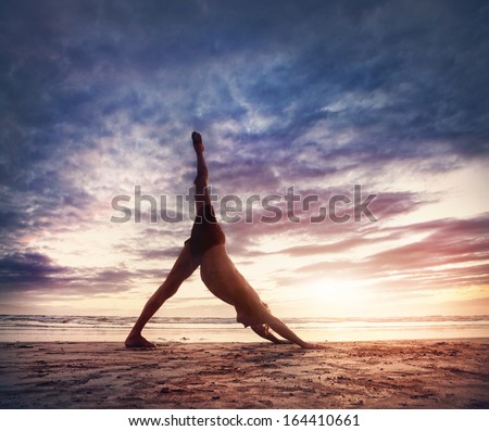 Man doing Yoga on the beach near the ocean in India Royalty-Free Stock Photo #164410661