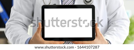 Male doctor holding digital tablet pc and showing screen to patient. Diagnostics tools and equipment therapeutist consultation information search document demonstration prescription concept