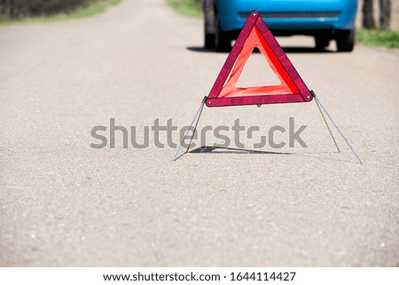 A breakage triangle on the road in front of the car
