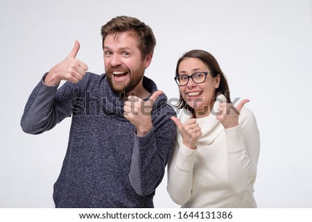 Mature caucasian couple man and woman showing thumbs up on white background