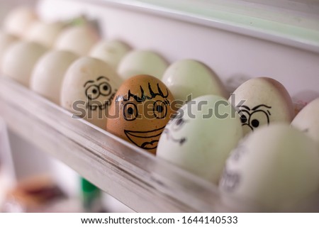 Emotionally eggs in the fridge tray. Real hand-painted eggs. . Many faces  photo.