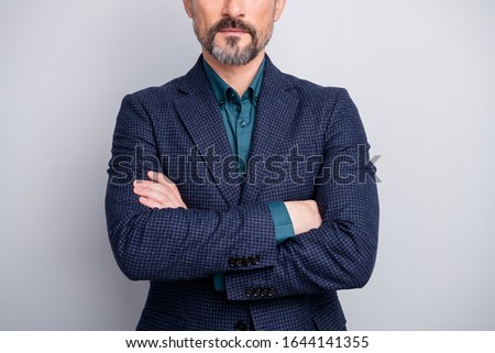 Cropped photo of attractive mature man hiding facial expression no smile perfect neat bristle arms crossed formalwear shirt blazer blue suit isolated grey color background
