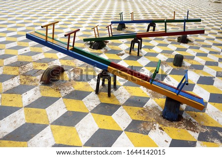 Some playgrounds feature a seesaw or teeter-tooter                             