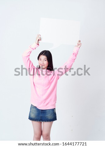 Portrait of teenage girl showing placard empty isolated on white background.