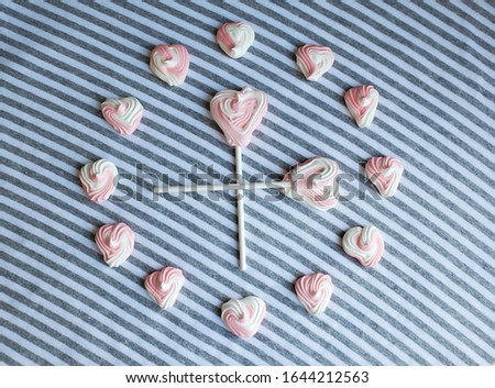 The clock made of sweet pink and white hearts