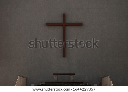 Christian wooden crucifix on a wall background The back of the christ church. copy space, selective focus.