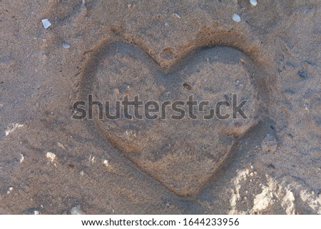 Heart drawn in the sand. Romantic Valentine's Day.