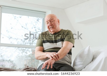 Senior man suffering from Parkinson syndrome in clinic Royalty-Free Stock Photo #1644236923