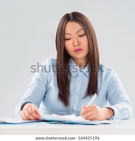 View of pretty business woman focusing on business plan