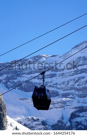 Black cable car cabin with mountains in the backgroung at the ski resort Seiser Alm, Italy.
