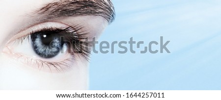  Beautiful blue eyes close up , web banner with copy space