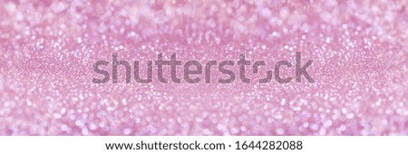 Abstract sparkle glitter lights background. Selective focus. 
Pastel pink color. Shine bokeh effect. For party, holidays, celebration. Banner for website. 