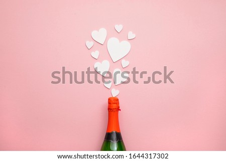 Romantic love hearts exploding from a bottle of champagne