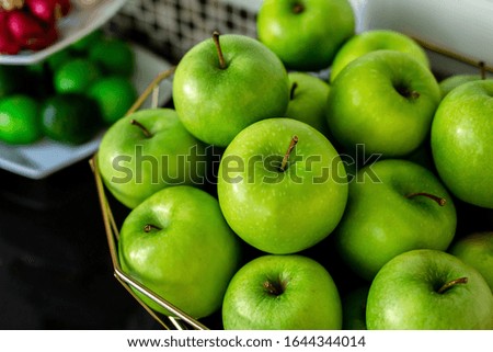 Green Apples and vegetable garden on the basket On the table to the kitchen