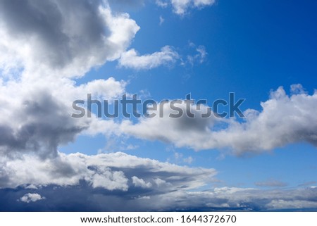 gloomy overcast clouds against a blue sky