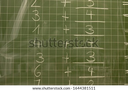 arithmetic problems are written on the board