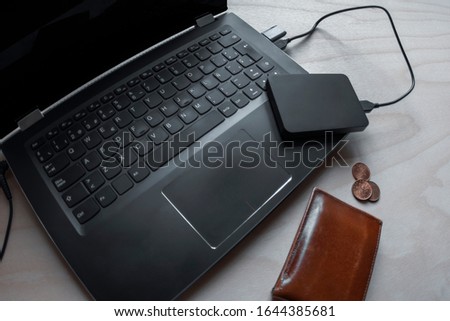 Laptop with hard drive, pen drive, coins and wallet