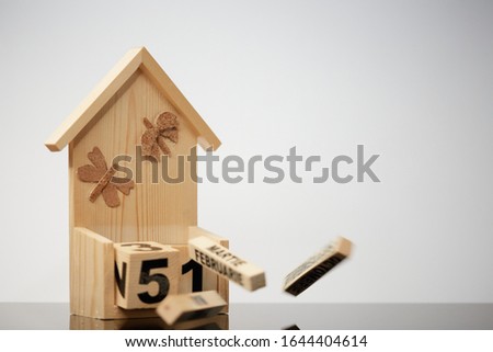 Wooden letters . A small wooden house on a wooden table