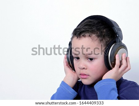 child with headphones enjoying music   on white background stock photo  