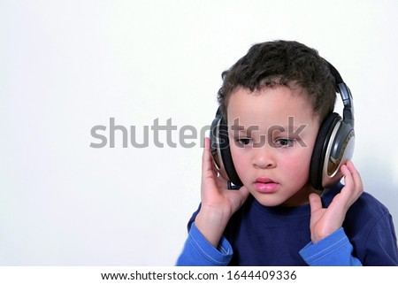 child with headphones enjoying music   on white background stock photo 