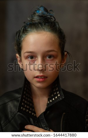 Portrait of nine year old girl. Teenager with blue strands on her hair. A series of photos of a girl of 8 or 9 years old. A teenage girl in a leather jacket. A teenager with collected hair in a bun.