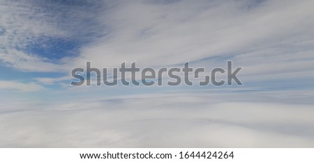 landscape of white clouds and blue sky photographed from a plane