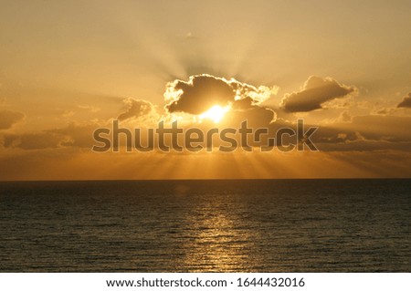 Sunset sky background. Dramatic gold sunset sky with evening sky clouds over the sea.