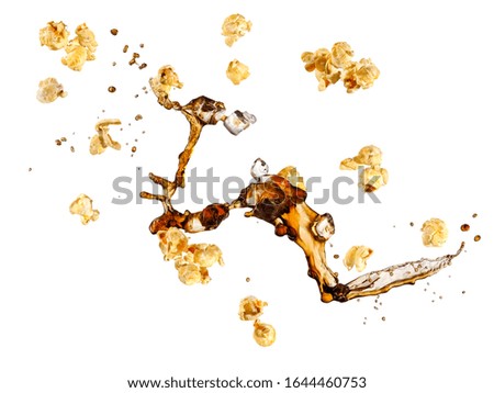 Flying buttered popcorn and cola with ice splash