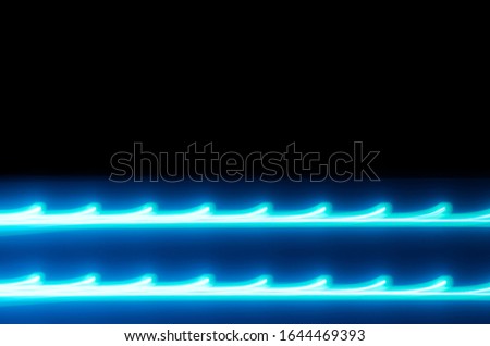 Blue light rays against a dark background