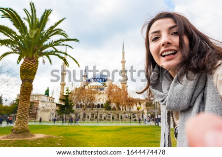 Beautiful woman traveler tourist take selfie with view of Sultanahmet Mosque or Blue Mosque,a popular destination for Tourists and locals in Istanbul,Turkey