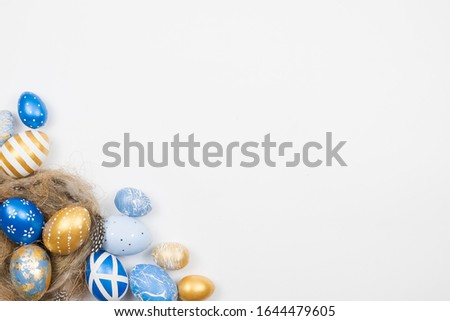 Easter golden decorated eggs in nest isolated on white background. Minimal easter concept. Happy Easter card with copy space for text. Top view, flatlay.